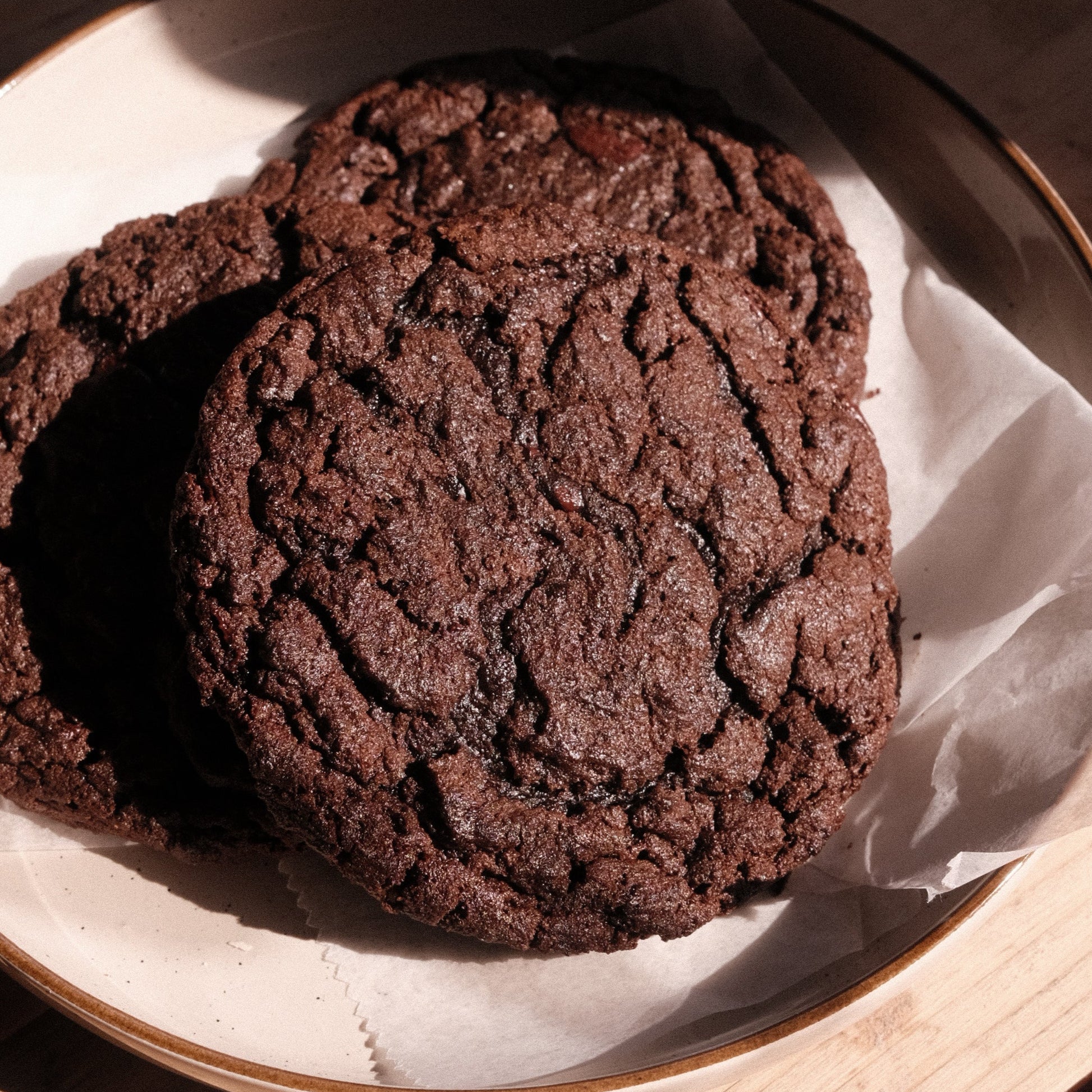 Three Vietnamese Mocha Cookies in a beige plate. 